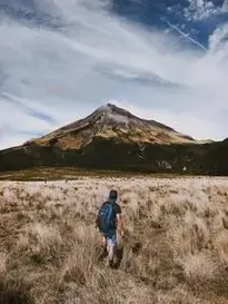 Man Standing on Open Field Under White Sky phone wallpaper background