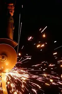 Flashing Sparks Coming From the Angle Grinder phone wallpaper background