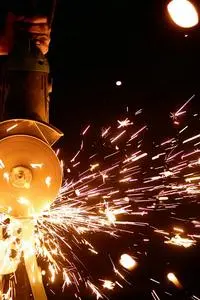 Flashing Sparks Coming From the Angle Grinder phone wallpaper background