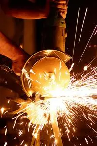 Flashing Sparks Coming From the Angle Grinder phone wallpaper background