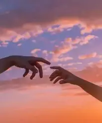 Crop anonymous people pulling hands to each other against bright sunset sky with clouds phone...