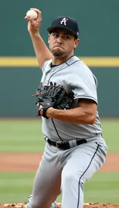 Baseball Pitcher In Grey Uniform Winding Up For A Throw