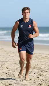 Beach Rugby Athlete In Sleeveless Kit Sprinting Across