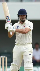 Cricket Batsman In Classic White Kit Playing A Cover Drive
