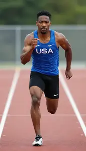 Full Body Photo Of A Sprinter In Fitted Blue Singlet And