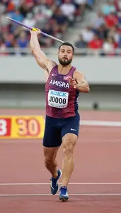 Javelin Competitor In Track Shorts Accelerating Before The