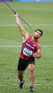 Javelin Thrower In Sleeveless Athletic Top Releasing The
