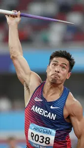 Javelin Thrower In Sleeveless Athletic Top Releasing Spear