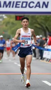 Marathon Participant In Racing Gear Crossing The Finish Line