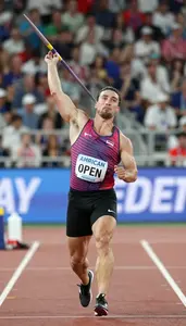 Open Field Javelin Competitor In Sleeveless Top Accelerating
