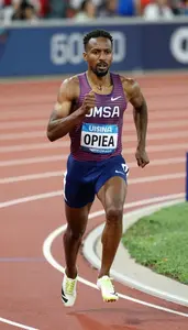Open Track Middle Distance Runner In Racing Spikes Surging