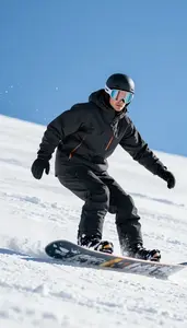 Snowboarder In Insulated Jacket Carving Sharply Down A Snowy