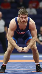 Wrestler In Competition Singlet Locking Arms With Opponent