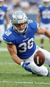 Action Shot Of A Football Defender In Blue Jersey Sliding To