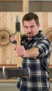 Axe Thrower In Flannel Shirt And Steady Aim Throwing A Sharp