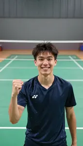A Badminton Player In A Sweat Soaked Shirt Celebrates A