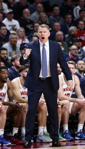 Basketball Coach In A Suit And Tie Yells Instructions From