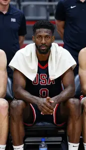 Basketball Player In A Jersey Sits On The Bench Towel Over