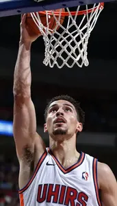 A Basketball Player In A Sleeveless Jersey Boxes Out Under