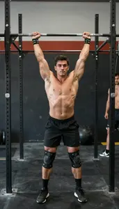 Crossfit Athlete In Lifting Shoes And Knee Sleeves