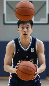 Indoor Basketball Player In Dark Jersey Preparing Free Throw