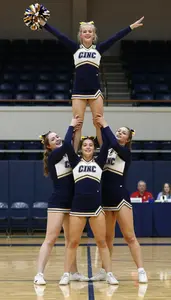Indoor Cheer Squad Member In Coordinated Uniform Performing