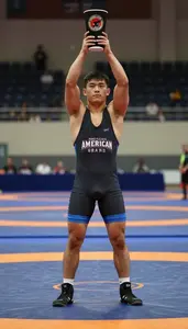 Indoor Wrestling Grand Champion In Snug Singlet Lifting A