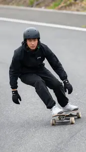 Longboarder In Relaxed Stance And Sliding Gloves Carving