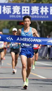 Marathon Participant In Racing Gear Crossing The Finish Line