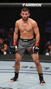 Mixed Martial Artist In Shorts And Wraps Shooting For A
