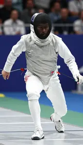 Modern Pentathlon Athlete In Fencing Attire Lunging On A