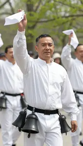 Morris Dancer In White Clothes And Bell Pads Waving