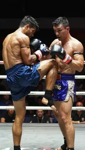 Muay Thai Fighter In Shorts And Wraps Delivering A Powerful
