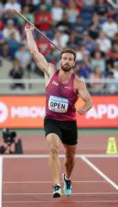 Open Field Javelin Competitor In Sleeveless Top Accelerating