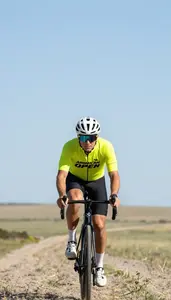 Open Prairie Long Distance Cyclist In Bright Jersey Riding