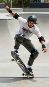 Skateboarder In Casual Sports Tee And Protective Pads