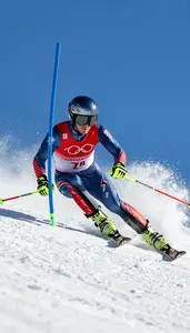 Ski Racer In Aerodynamic Suit And Helmet Carving A Sharp
