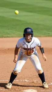 Softball Player In A Dirt Stained Uniform And Helmet Helmet