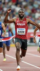 Sprinter In Red And Black Track Outfit Crossing Finish Line