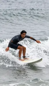 Surfer In Boardshorts Paddles Hard Arms Digging Into The