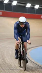 Track Cyclist In Tight Racing Skinsuit Pedaling Hard On A