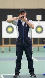 Trap Shooter In Casual Vest And Relaxed Stance Calling Pull