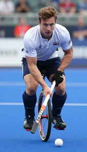 Unicycle Hockey Player In Team Kit And Stick Handling