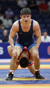 Wrestler In Tight Singlet Attempting A Takedown On A
