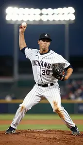 Baseball Pitcher In Pinstriped Uniform And Dirt Stained