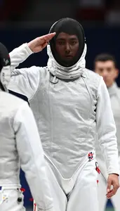 Fencer In Full Gear Mask On Salutes Their Opponent Before A