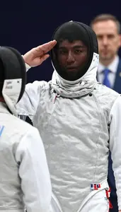 A Fencer In Full Gear Mask On Salutes Their Opponent Before