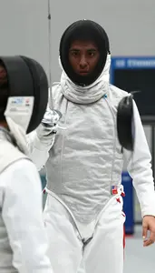 Fencer In A White Jacket And Mask Mask Off Talks To Their