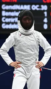 Fencer In A White Jacket Mask Under Arm Looks At The