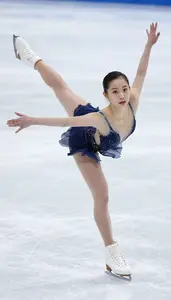 Figure Skater In Elegant Dress And Blades Extended In A